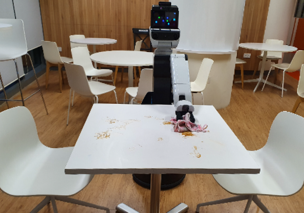 智能机器人在餐馆中自动清洁桌面上的食物残渣